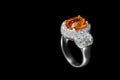 Diamond ring with topaz isolated on black background