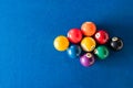 Diamond shape of 9-ball pool balls placed in rack position on blue felt table