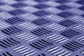 Diamond shaped metal floor pattern with blur in blue tone. Royalty Free Stock Photo