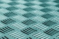 Diamond shaped metal floor pattern with blur in cyan tone. Royalty Free Stock Photo
