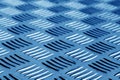 Diamond shaped metal floor pattern with blur in navy blue tone. Royalty Free Stock Photo