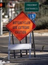 A diamond shaped road sign advising motorcyle riders to use extreme caution