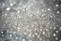 Diamond silver dust on a gray background. glitter texture. water drops macro