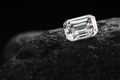 A diamond is sitting on a rock Royalty Free Stock Photo