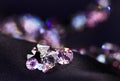 Diamond (small purple jewel) heap over black silk Royalty Free Stock Photo