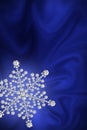 Diamond snowflake on a blue silk.