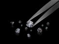 Diamond in tweezers on a black background with diamonds group soft focusing