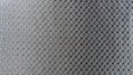 Diamond woven Black carbon fiber composite material background close up view