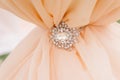 Diamonds brooch on peachy satin as a background