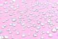 Diamonds, rhinestones on a pastel pink background. Beautiful festive backdrop. Crystals for nail art, makeup, and design