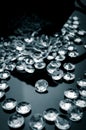 Diamonds scattered on a shiny surface Royalty Free Stock Photo