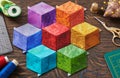 Diamonds stitched in the form of a cubes in the colors of the rainbow, quilting and sewing accessories Royalty Free Stock Photo