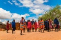 Massai men, wearing traditional blankets, overlooks Serengetti in Tanzania and Kenya in traditional massai village