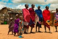 Massai men, wearing traditional blankets, overlooks Serengetti in Tanzania and Kenya in traditional massai village