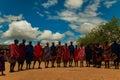 Massai men, wearing traditional blankets, overlooks Serengetti in Tanzania and Kenya in traditional massai village