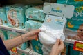 Diapers `Pampers` in hands in a supermarket. Minsk, Belarus - March 2021