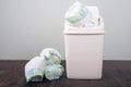 Diapers waste, dirty diapers in garbage pail Disposing of used baby nappies. Environmental Impact of Disposable Diapers. Pollution