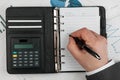 Diary, calculator, hand and pen Royalty Free Stock Photo