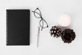 Diary christmas composition. stylish arrangement of cones and candle on white background. flat lay top view.