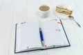 Diary with cup of coffee and piece of cake Royalty Free Stock Photo