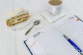 Diary with cup of coffee and piece of cake Royalty Free Stock Photo