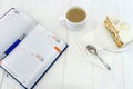Diary with cup of coffee and piece of cake Royalty Free Stock Photo