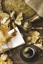 Diary, cup of hot coffee, autumn oak leaves, Turkish coffee pot on a wooden background. Copy space. Cozy. Autumn concept Royalty Free Stock Photo