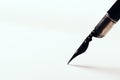 Old fountain pen with clipping path write on white paper background Royalty Free Stock Photo