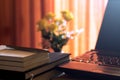 Diary and labtop for work on wooden table with flower and red curtain,notebook,book,pen,diary,clock and on wooden desk,Working Royalty Free Stock Photo