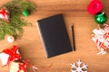 Diary mockup for Christmas. fir branches, christmas gift and decorations on wooden background