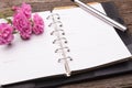 Diary note with pink rose on old wood Royalty Free Stock Photo