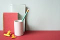 Diary notebook, pencil holder, clip on red desk. gray wall background. workspace Royalty Free Stock Photo