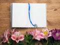 Diary or notebook with spring flowers on wooden background. close up Royalty Free Stock Photo