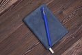 A diary with a pen on a brown wooden table Royalty Free Stock Photo