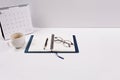 A diary, pen, calendar, and glasses are placed with a coffee cup Royalty Free Stock Photo