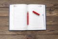 Diary, pen fountain red on a wooden background. Royalty Free Stock Photo