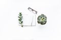 Diary, pen, green leaves eucalyptus and glasses on white background. flat lay, top view