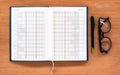 Diary planner book open calendar page with glasses and pen on th Royalty Free Stock Photo