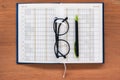 Diary planner book open calendar page with glasses and pen Royalty Free Stock Photo