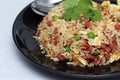 Dice Bacon Fried rice in black dish Royalty Free Stock Photo