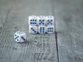 Pyramid of blue-and-white dice on wooden table. Royalty Free Stock Photo