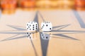 Dice and checkers on a wooden backgammon board Royalty Free Stock Photo