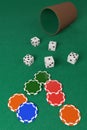 Dice and dice cup and chips on a green cloth. 3d illustration Royalty Free Stock Photo