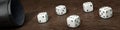 Dice cup and 5 dices on wooden table top Royalty Free Stock Photo