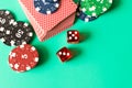 Dice, deck of cards and poker chips on a turquoise background. C