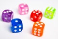 Dice of different colors isolated on a white background. Royalty Free Stock Photo