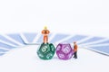 Dice divination with miniature worker with tarot card on background, astrological dices fortune telling divination tools