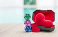 Dice divination with red heart in plastic box over blurred background, astrology dice fortune telling divination tools