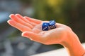 Dice 1 3 in the female hand, sunset background. Gambling devices. Royalty Free Stock Photo