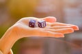 Dice 3 5 in the female hand, sunset background. Gambling devices. Royalty Free Stock Photo